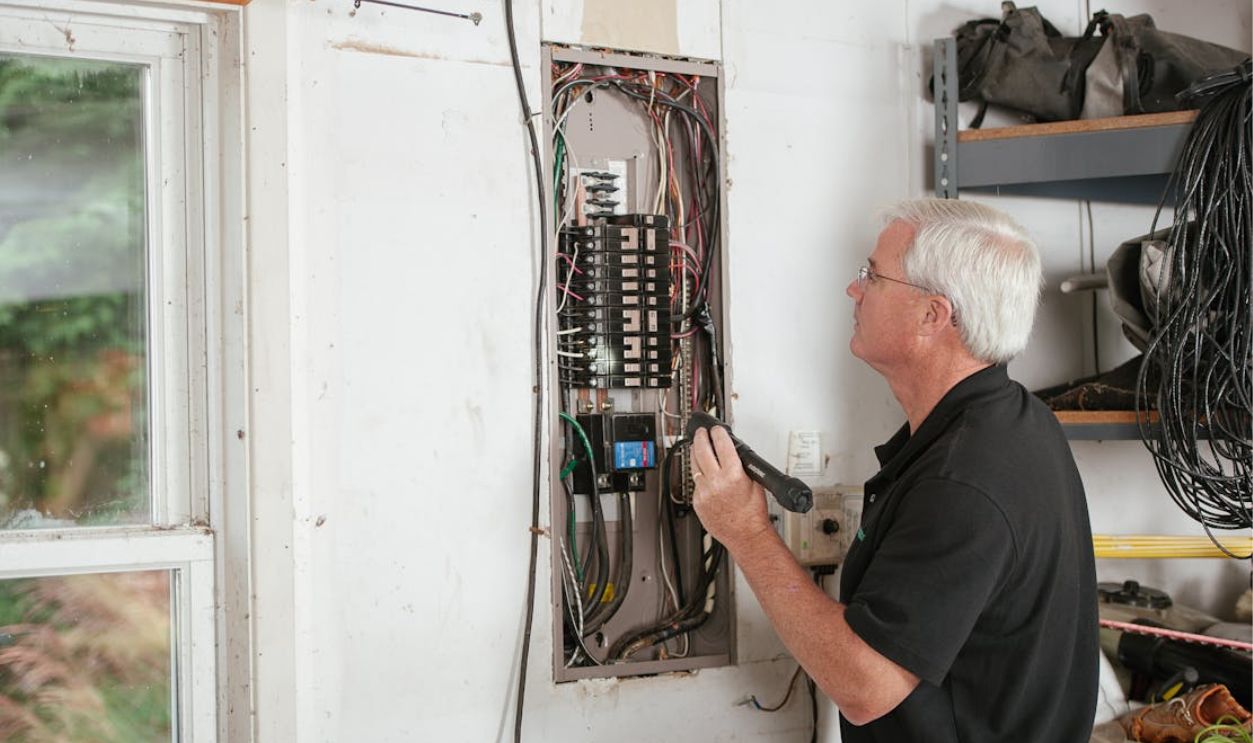 Electrician Inspecting Residential Fuse Box Area