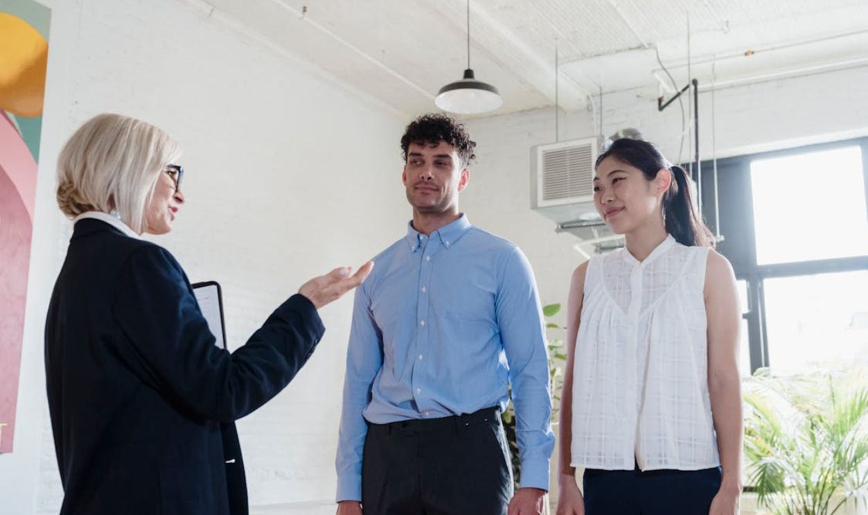 An Elderly Woman Talking to the Couple in front of Her