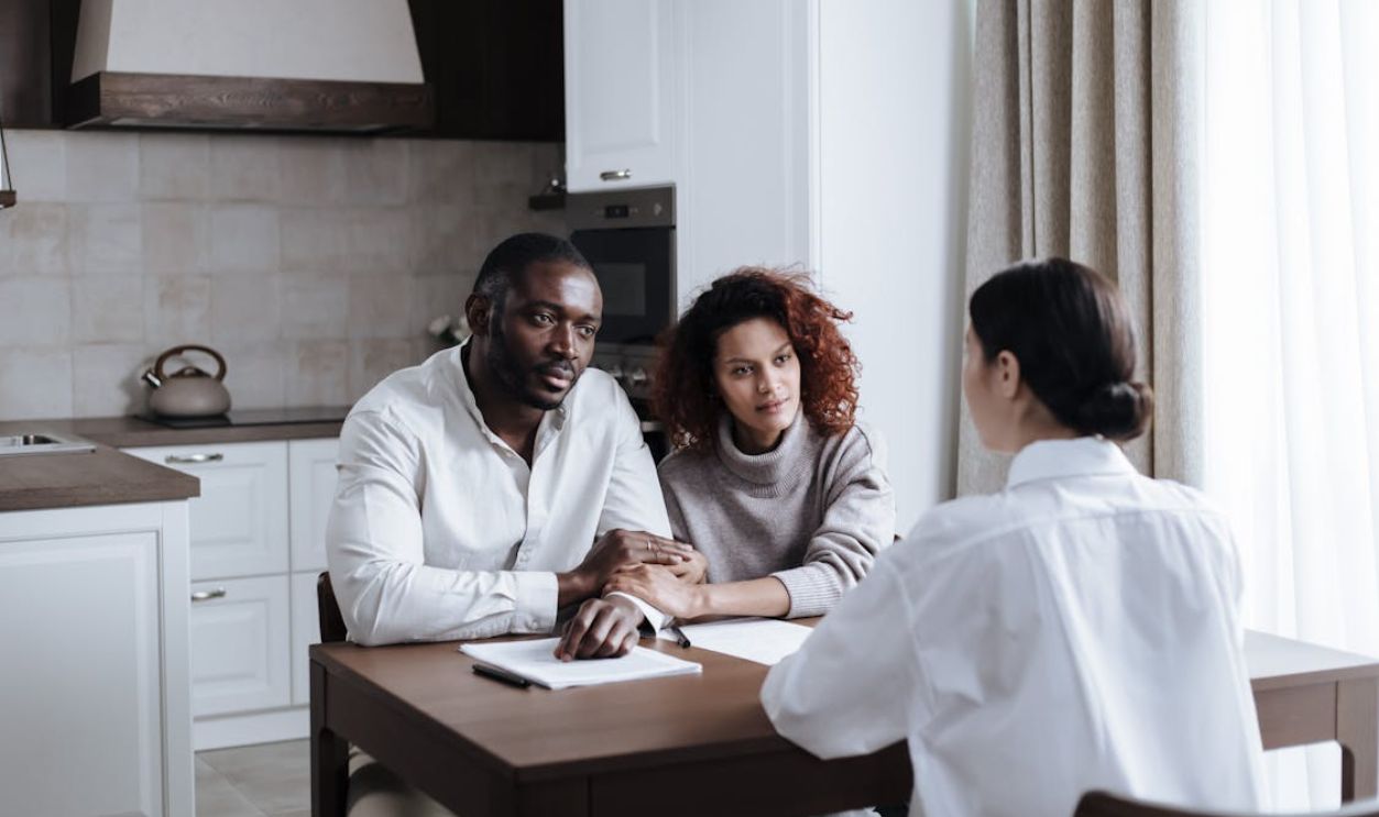 Couple Talking with Social Worker in Kitchen