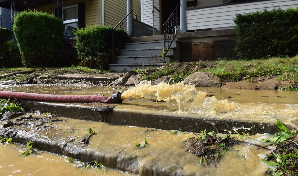 Water being pumped from a flooded basement