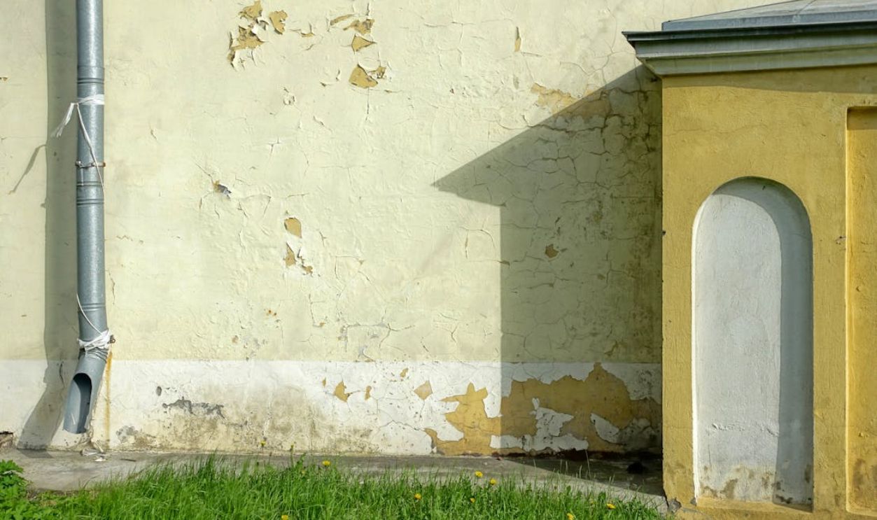 Old Wall with Cracked Paint and Downpipe Detail