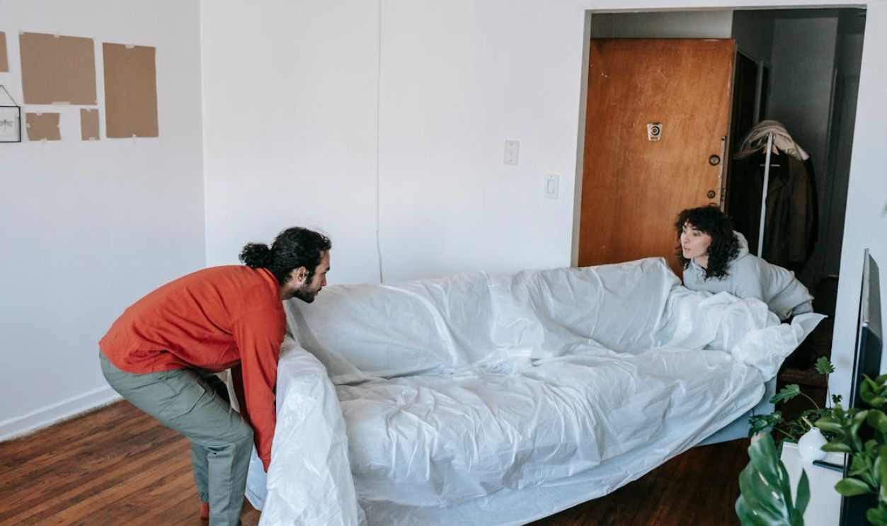 A Couple Lifting A Couch