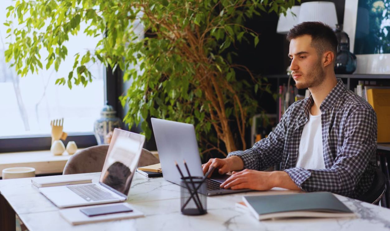 A Man Sitting using Laptop