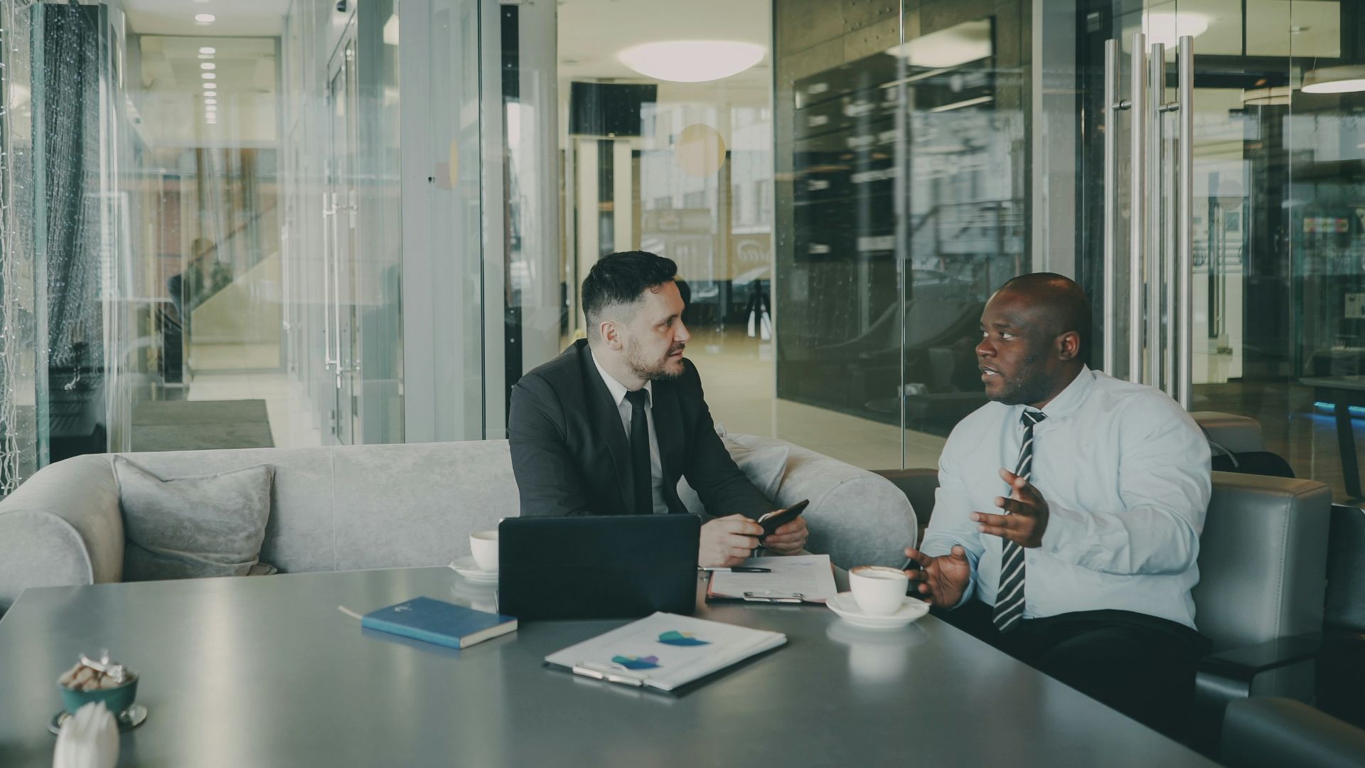 Two businessmen talking at a table