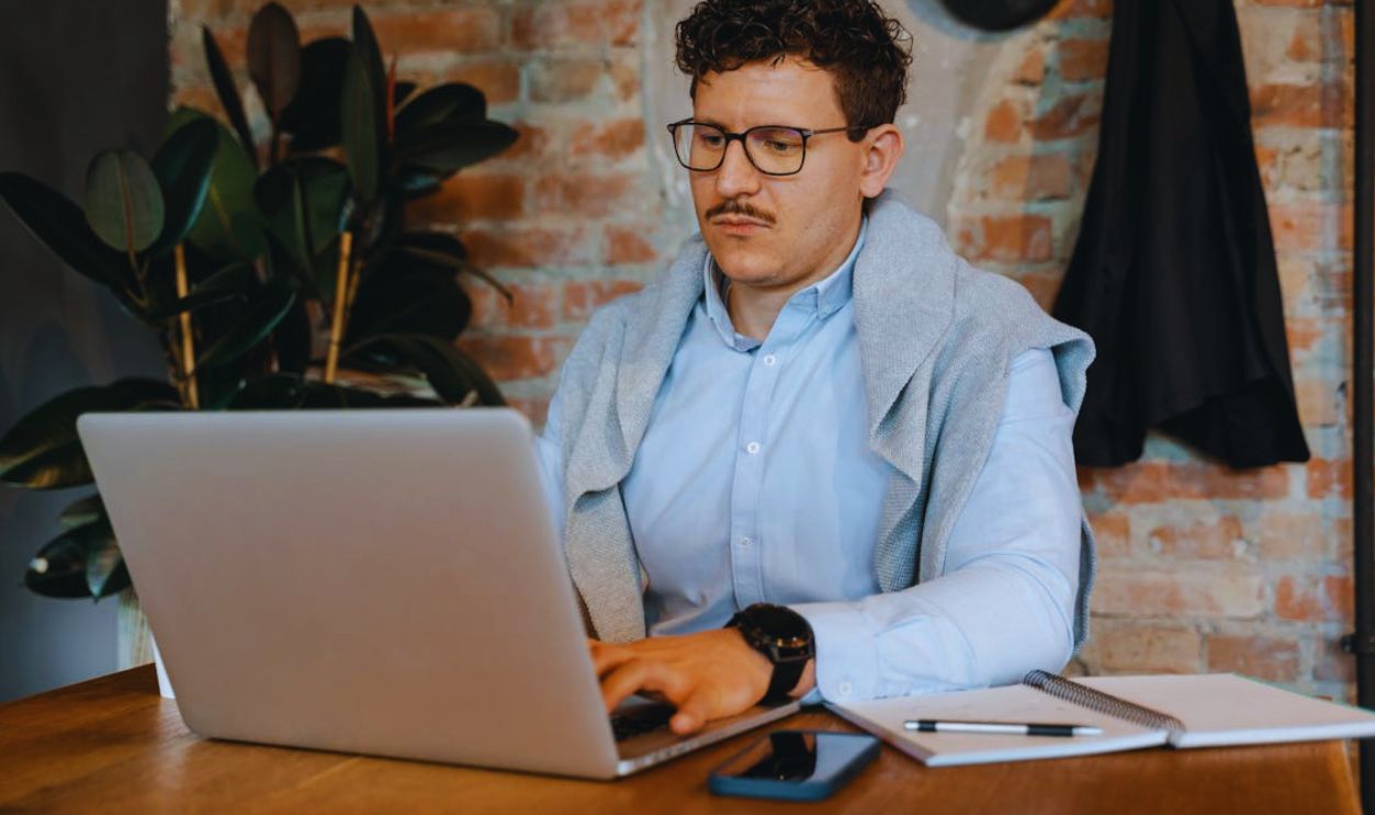 Man in Gray Dress Shirt Using Macbook Pro