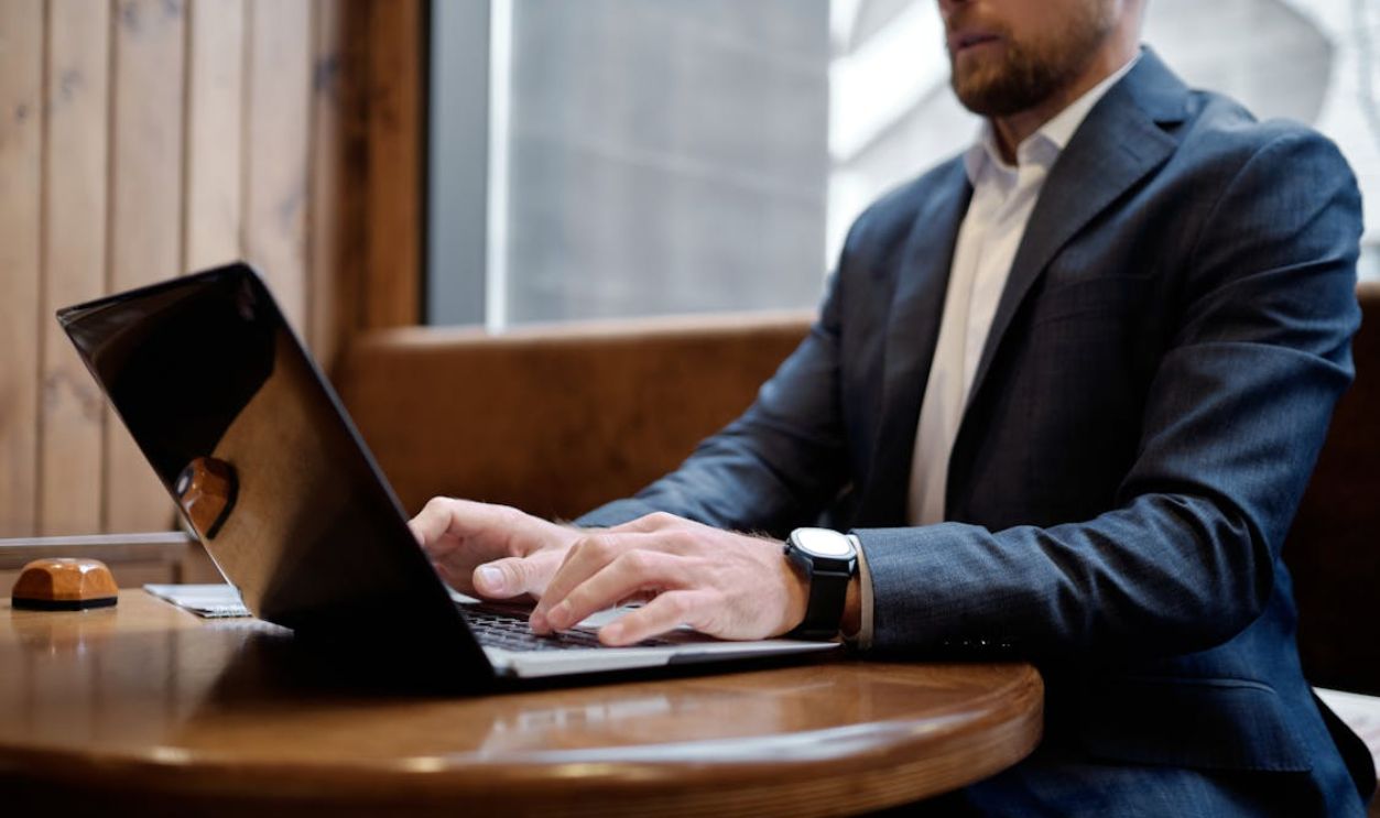Person in Suit Jacket Using a Laptop