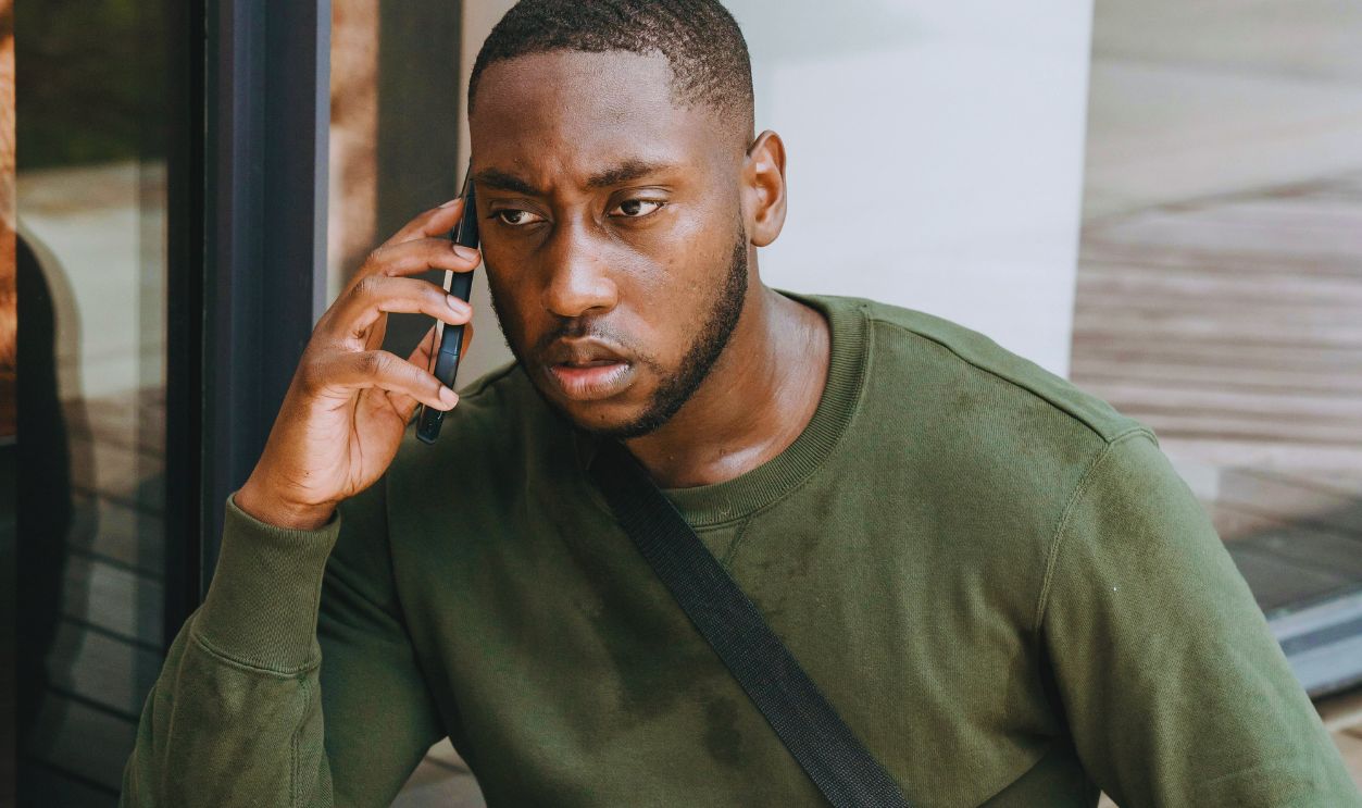 Man in a Green Long Sleeve Shirt Talking on the Phone