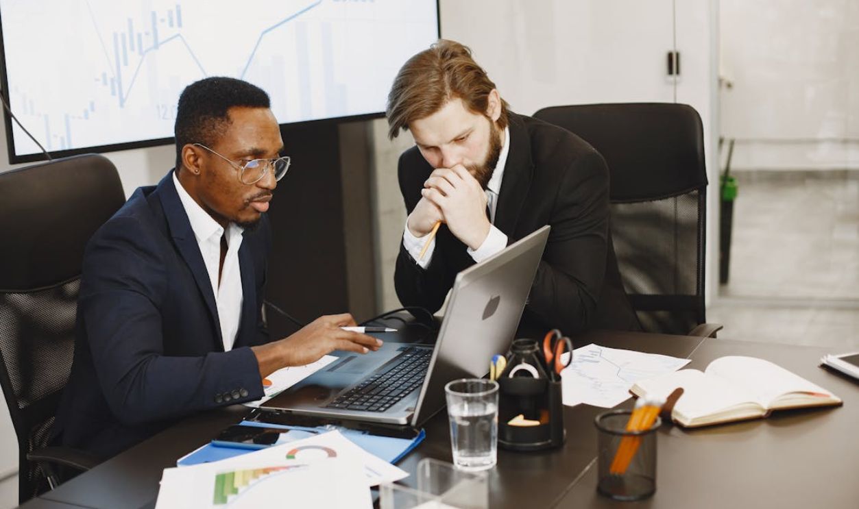 Men Working in an Office Using Laptop