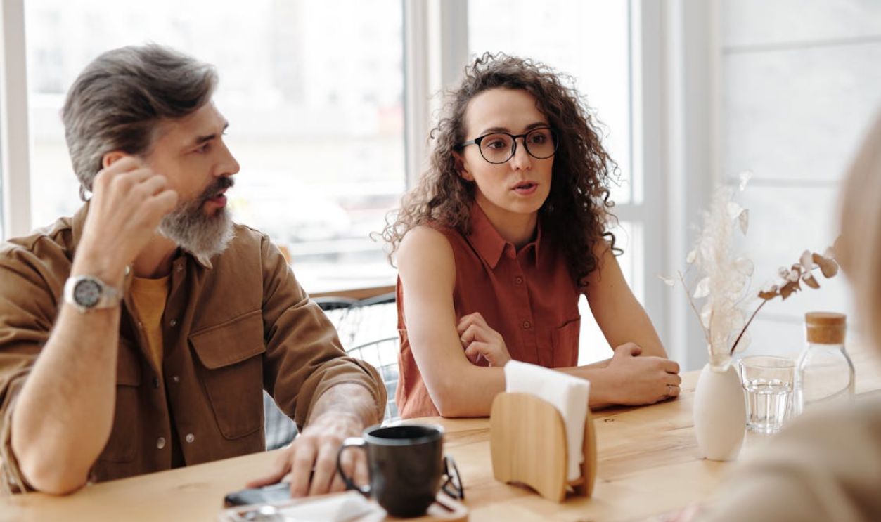 A Man and Woman Sitting at the Table Together