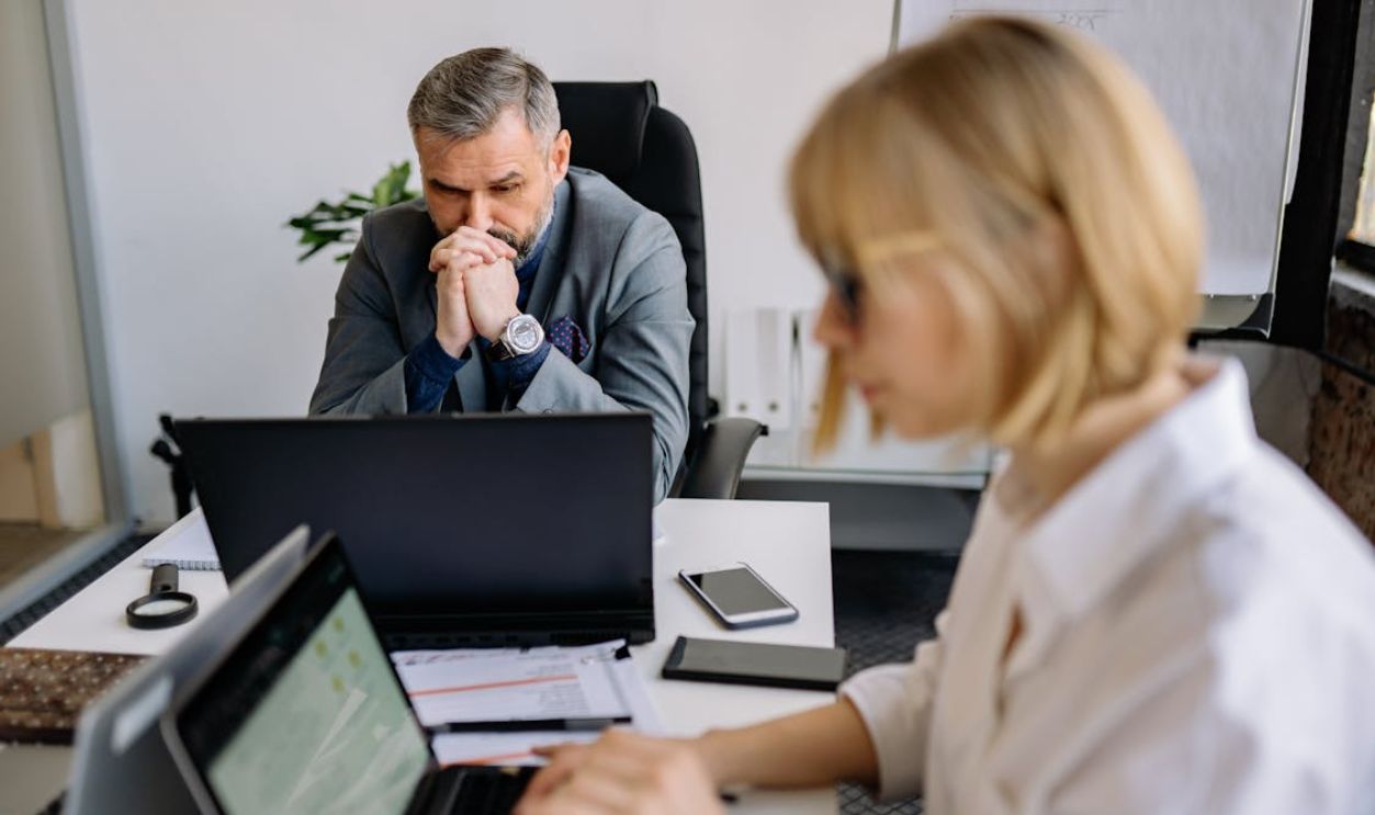 A Man and a Woman Using Wireless Laptops