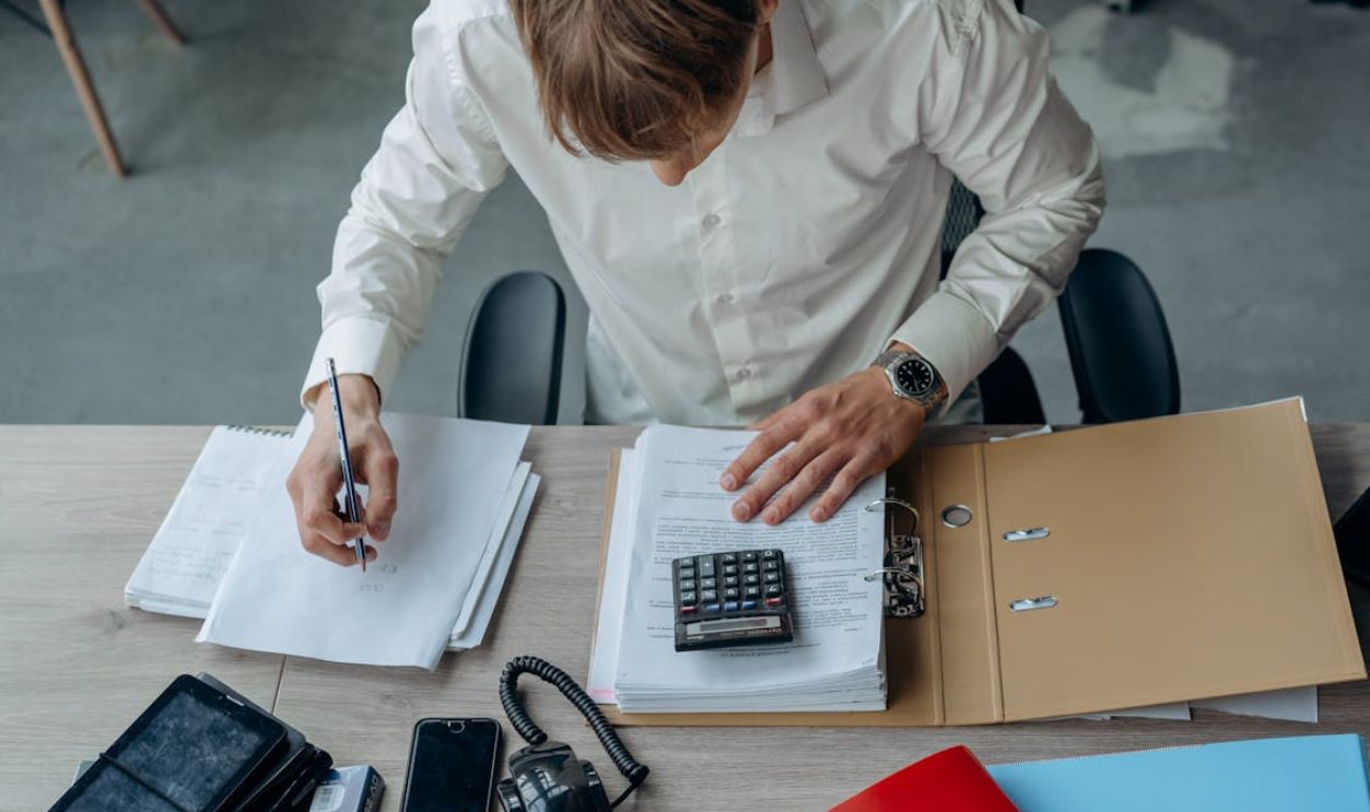 A Man Using a Calculator