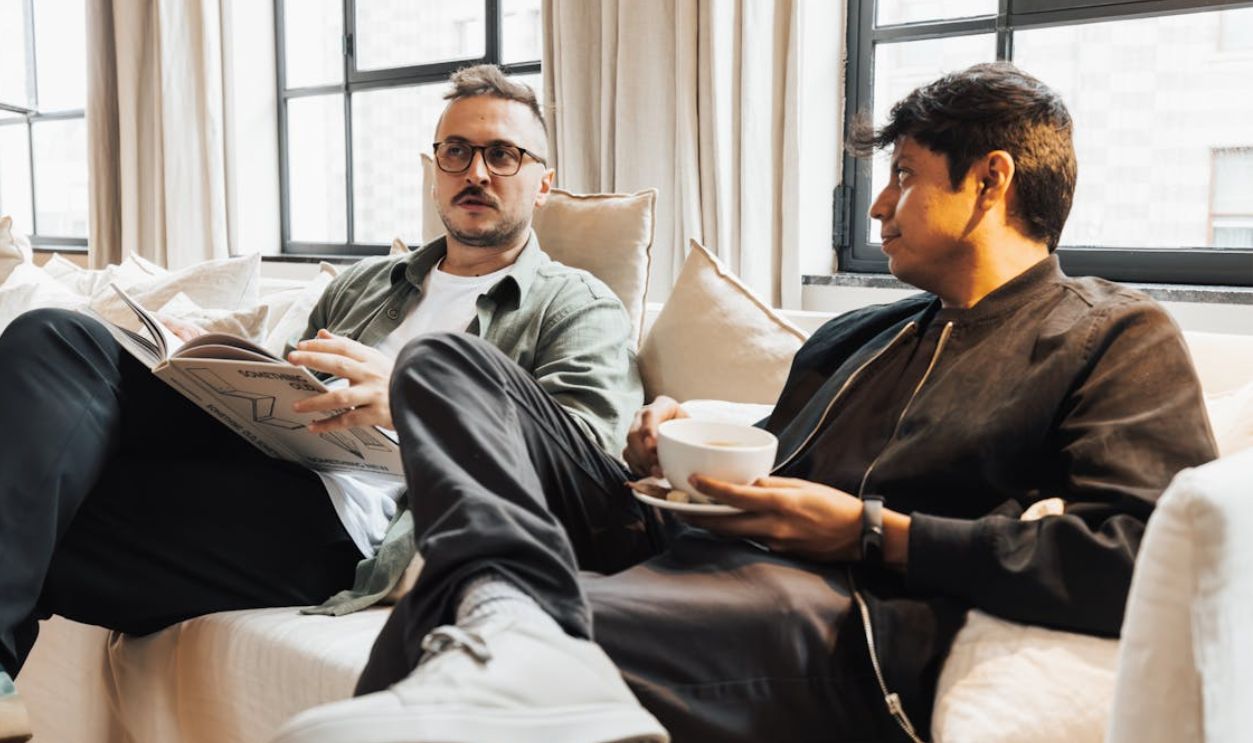 Two Men Talking on Sofa