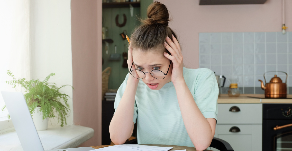 Young anxious worrying woman looks desperately to bills