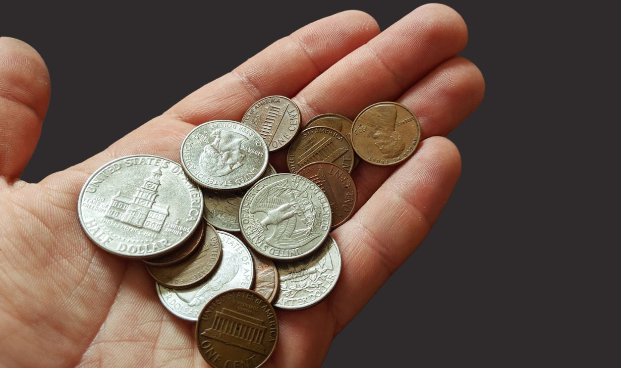 Pile of coins sitting in a man hand
