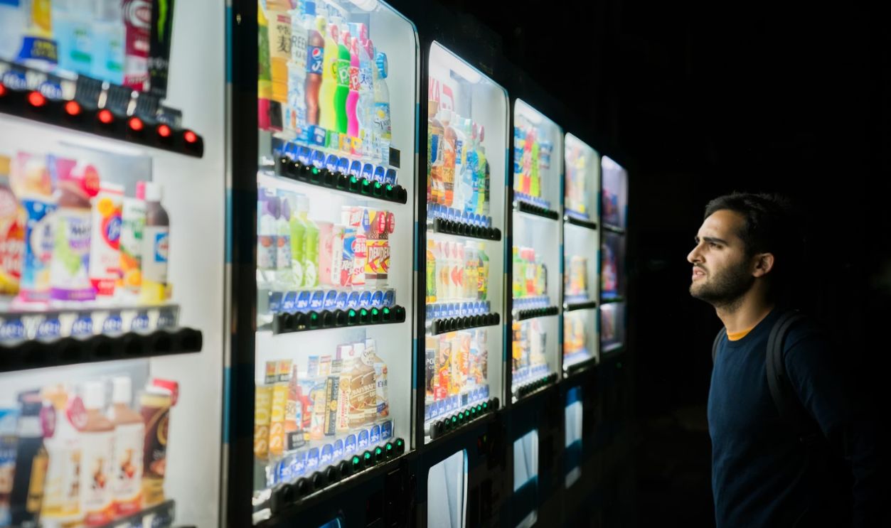 man on front of vending machines at nighttime