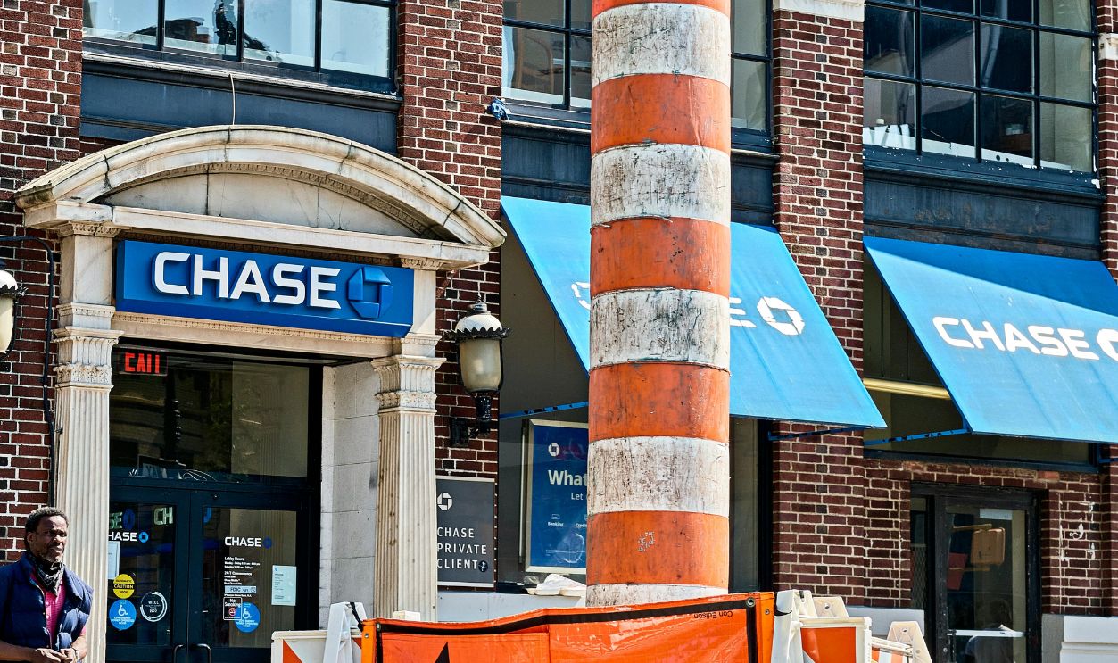 Arrow Sign, Chimney and Building on City Street