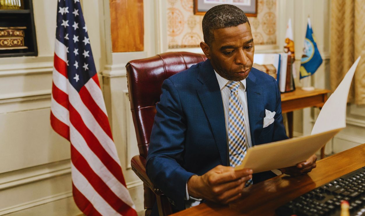 A Man in Suit while Reading a Document
