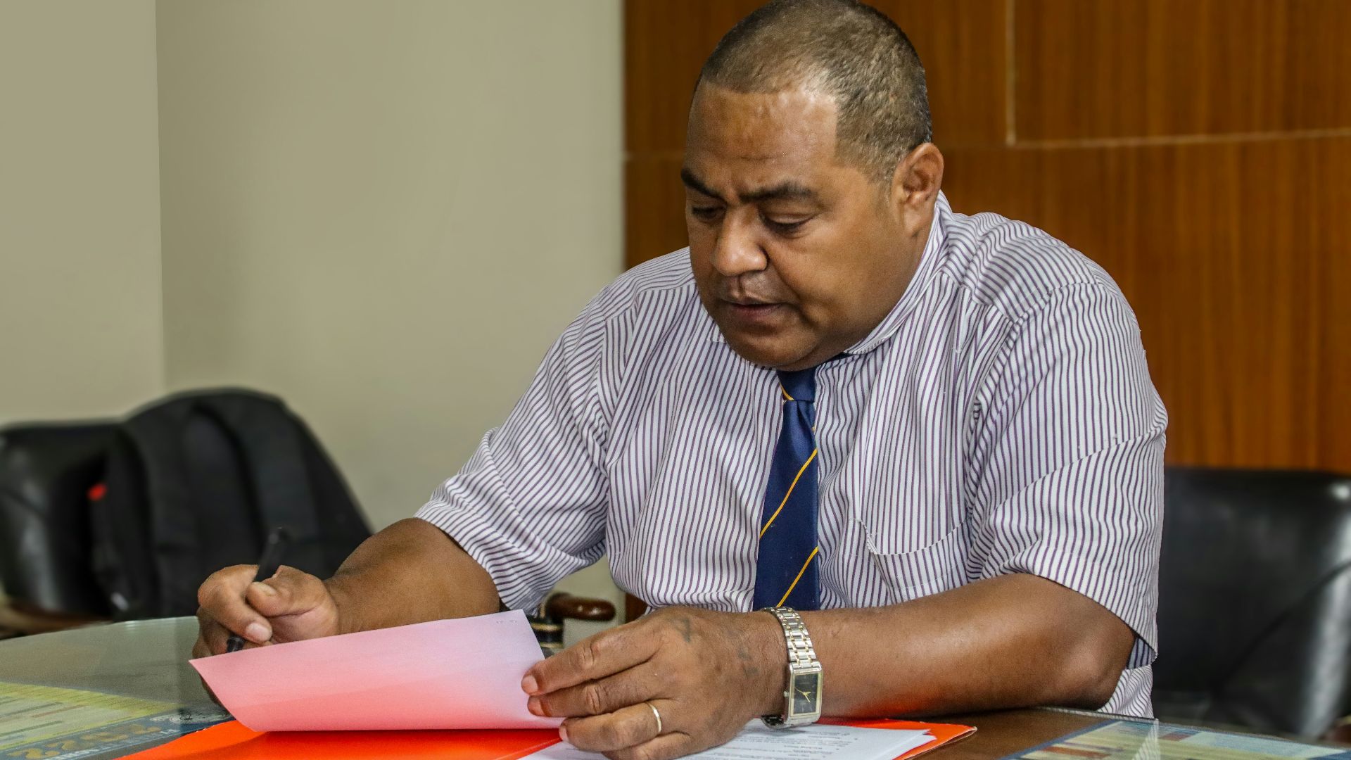 a man sitting at a table with papers in front of him