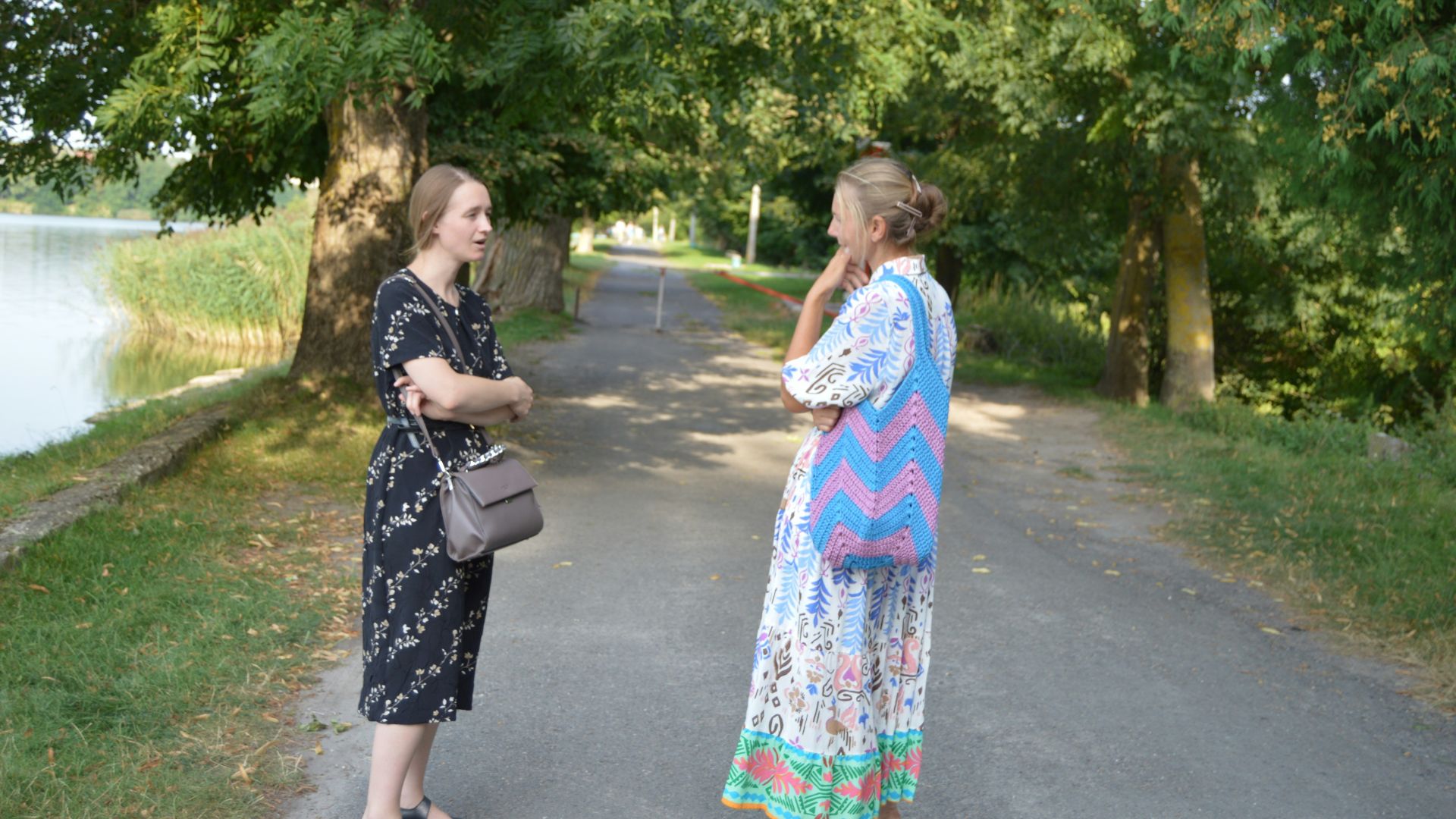 two women standing on a path talking to each other