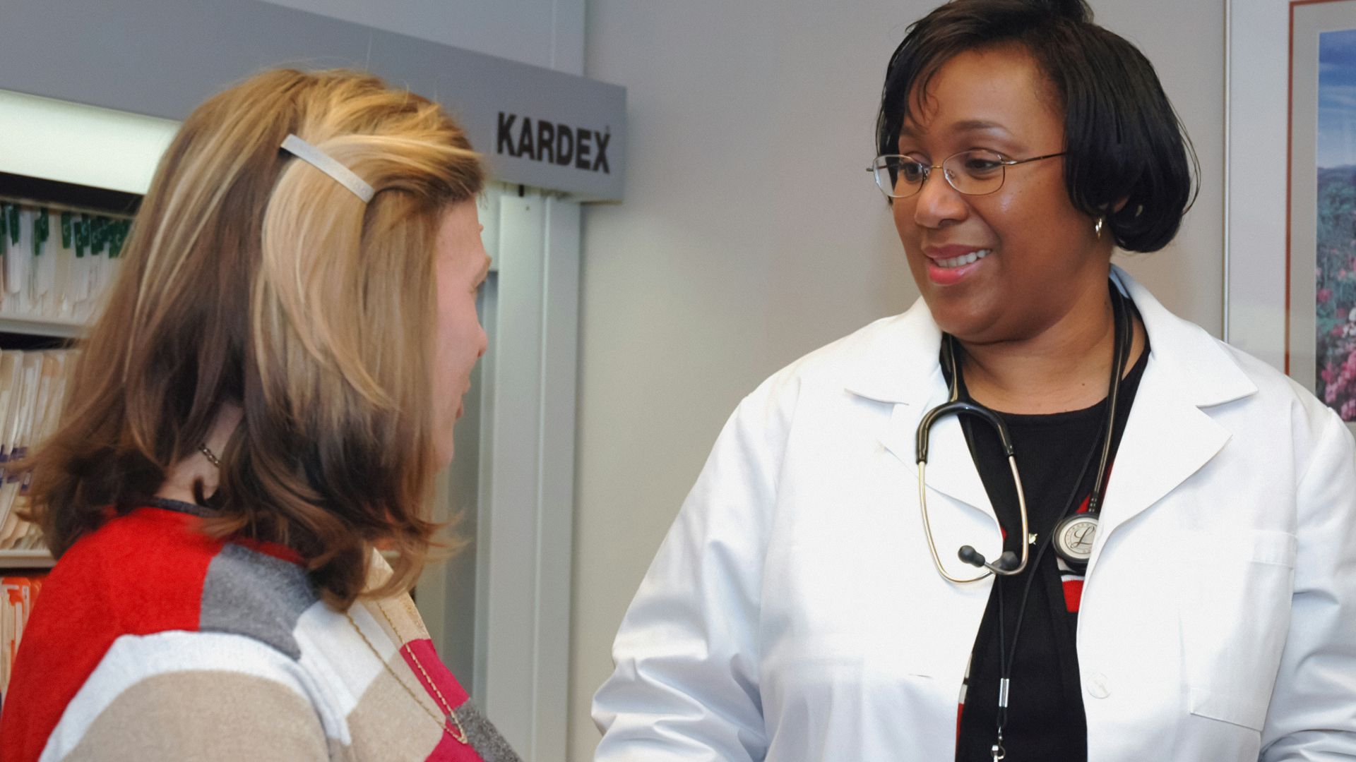 woman in white button up long sleeve shirt holding white card