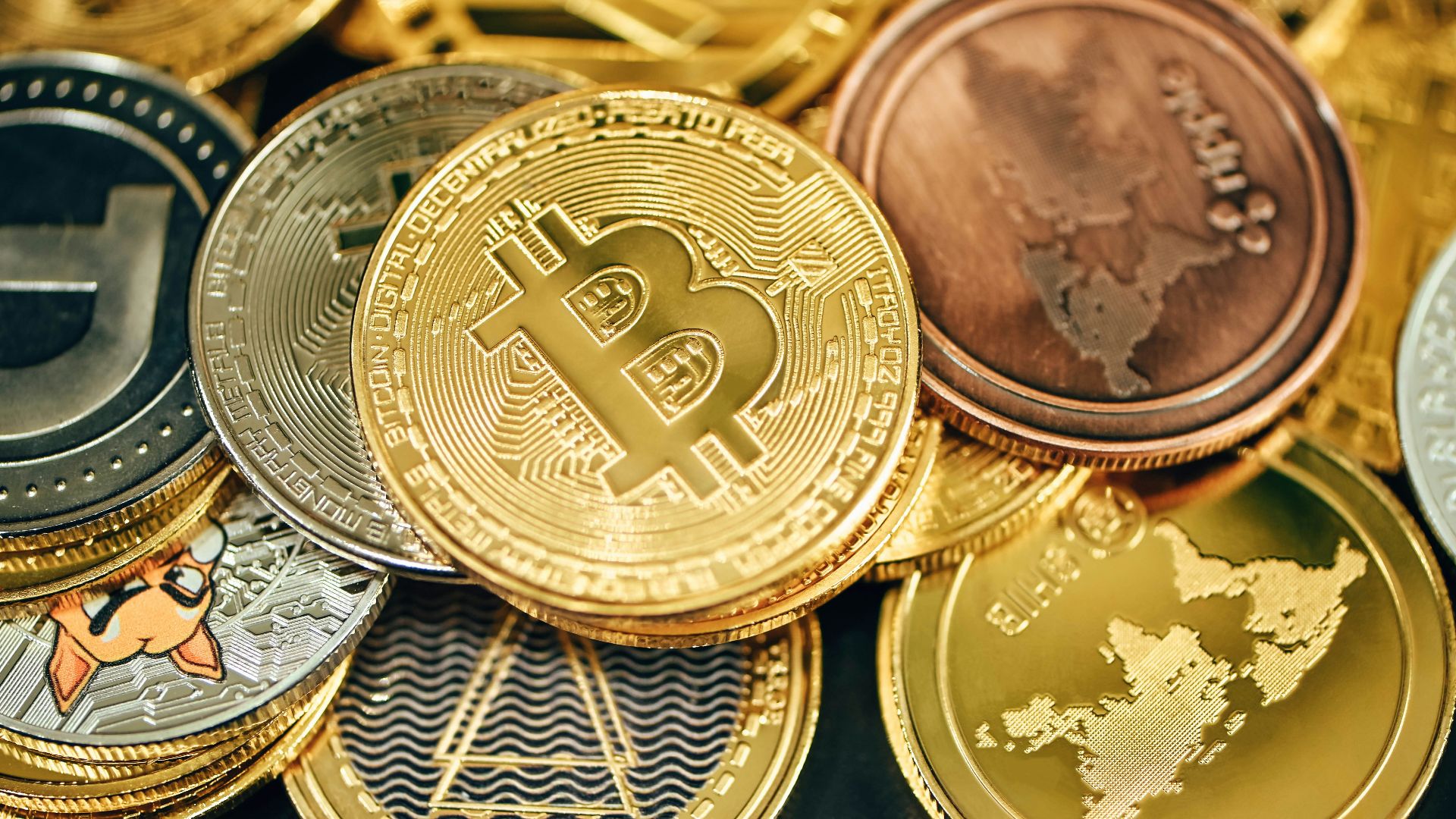 a pile of gold and silver bitcoins