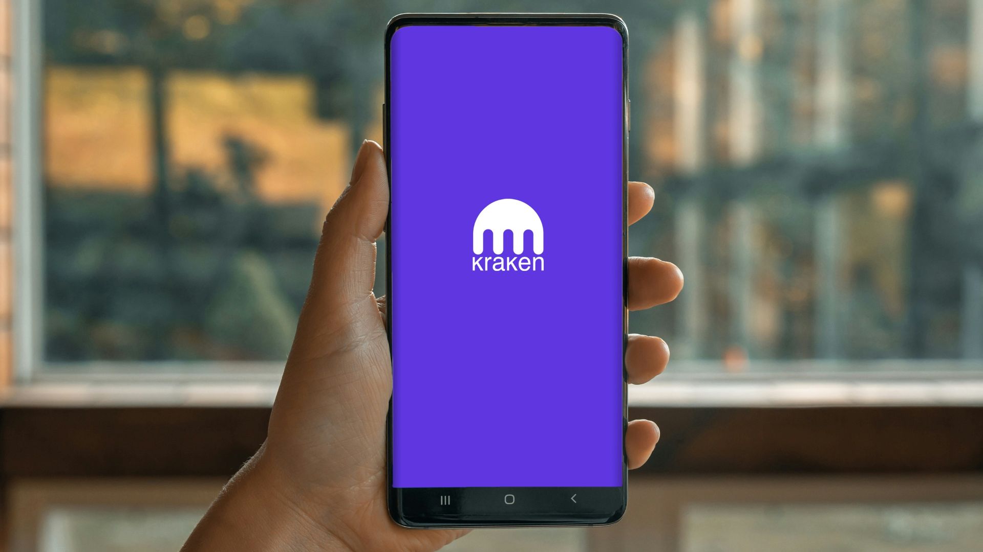 a hand holding a cell phone