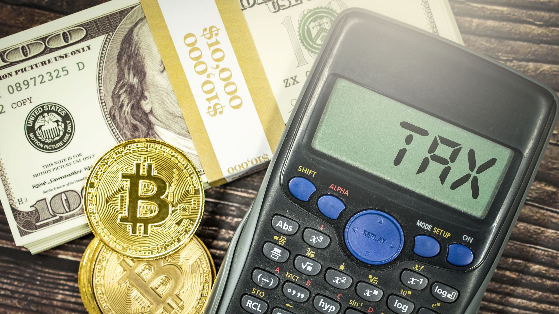 Cryptocurrency tax concept image that shows crypto medallions alongside some cash and a calculator that shows the word 'tax' on the screen. This image is licensed under the Attribution Creative Commons licence, which means you can use it as long as you credit the image owners by linking to www.bybit.com