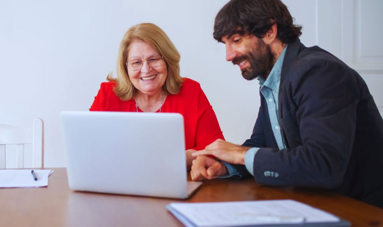 Man and Woman Looking at the Laptop Screen
