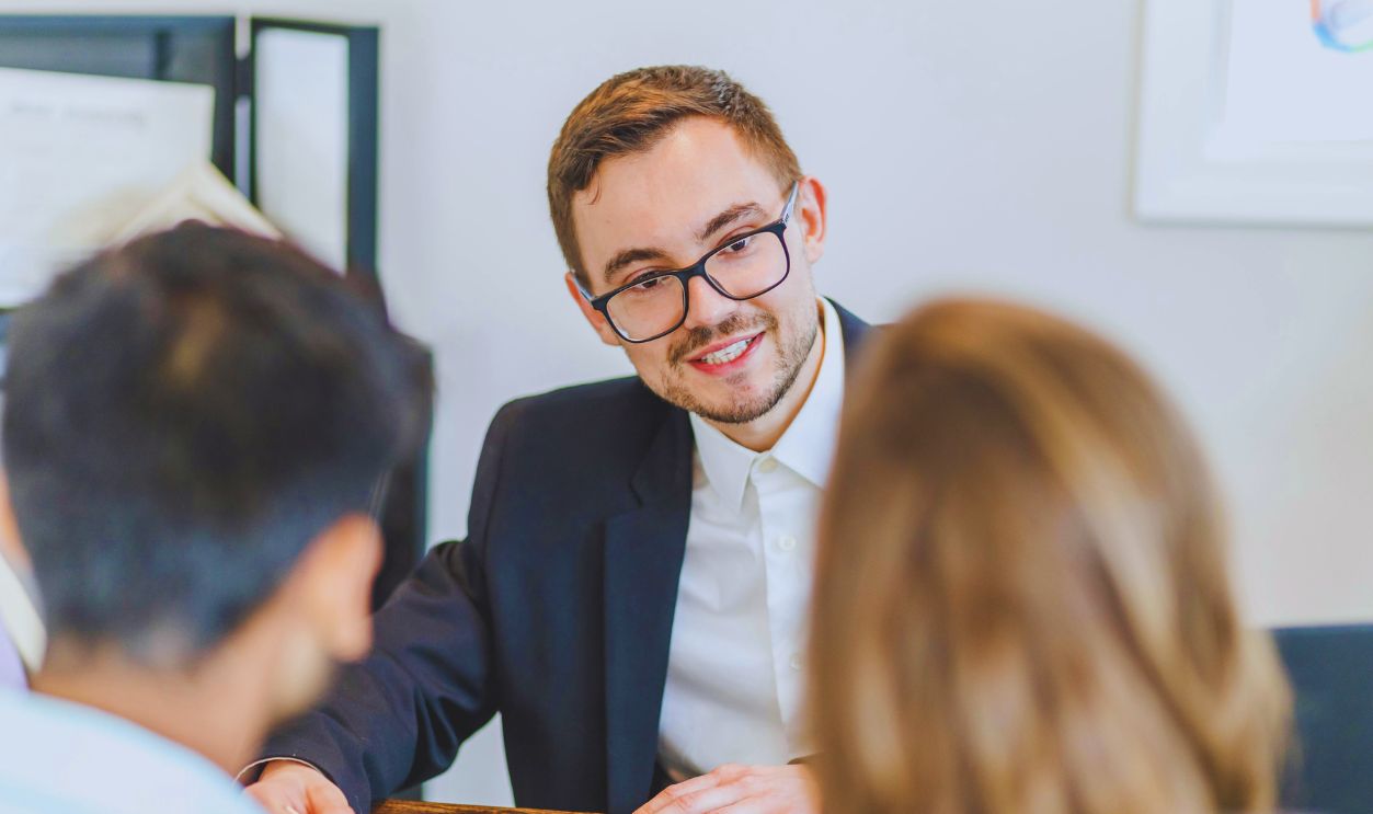 Man in a Black Suit Jacket Wearing Eyeglasses