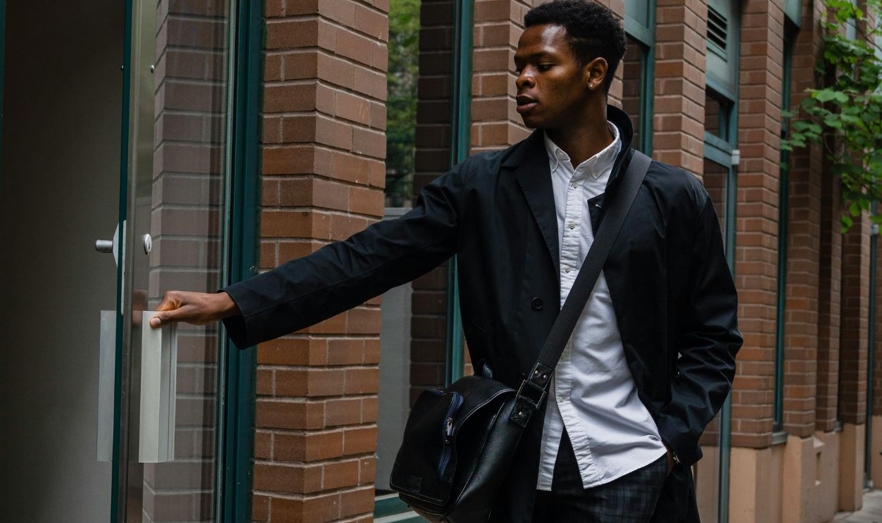 Photo of a Man Opening a Door