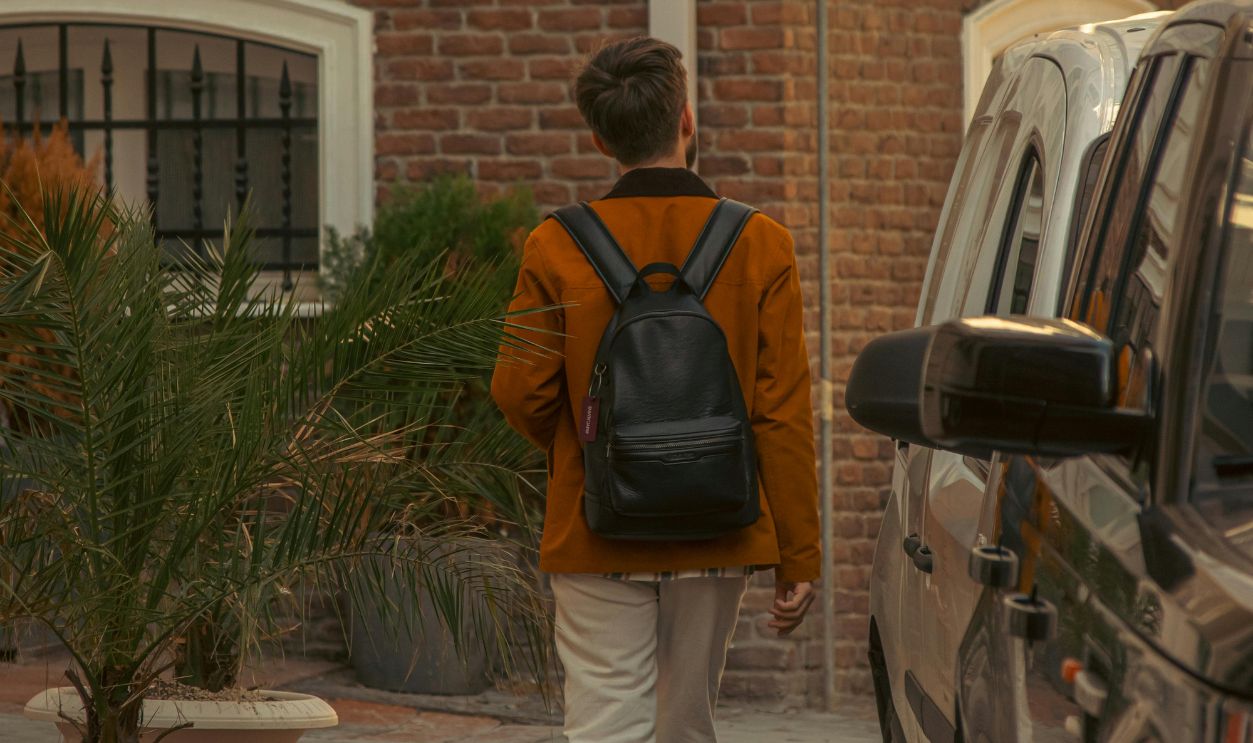 Back View of a Man Wearing a Black Backpack