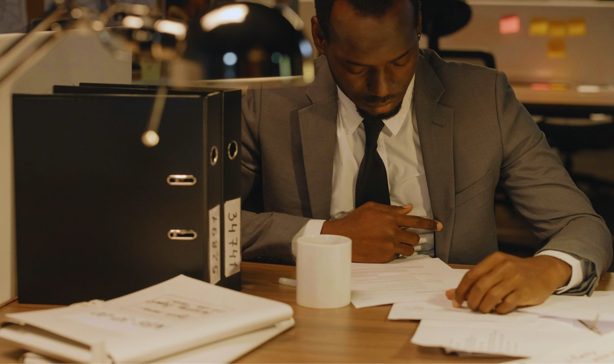 Man in Gray Suit Jacket Looking at the Documents