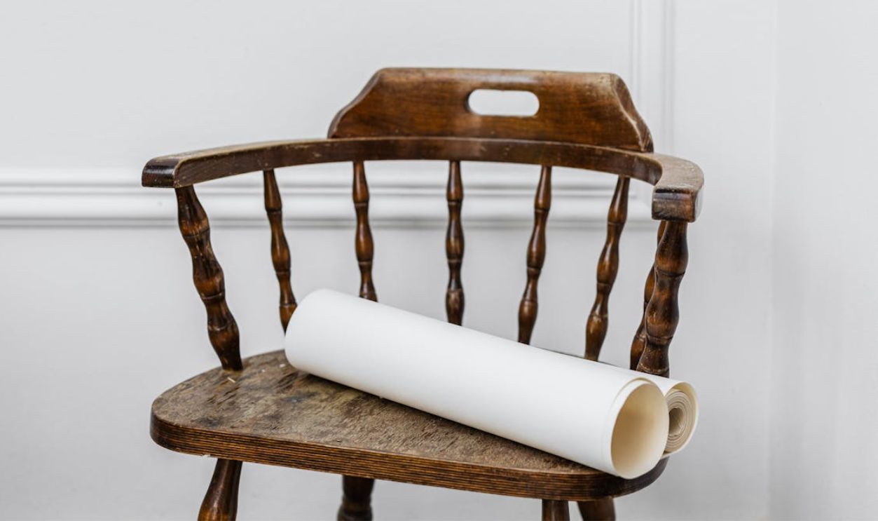 Close-up of Papers Lying on Antique Chair