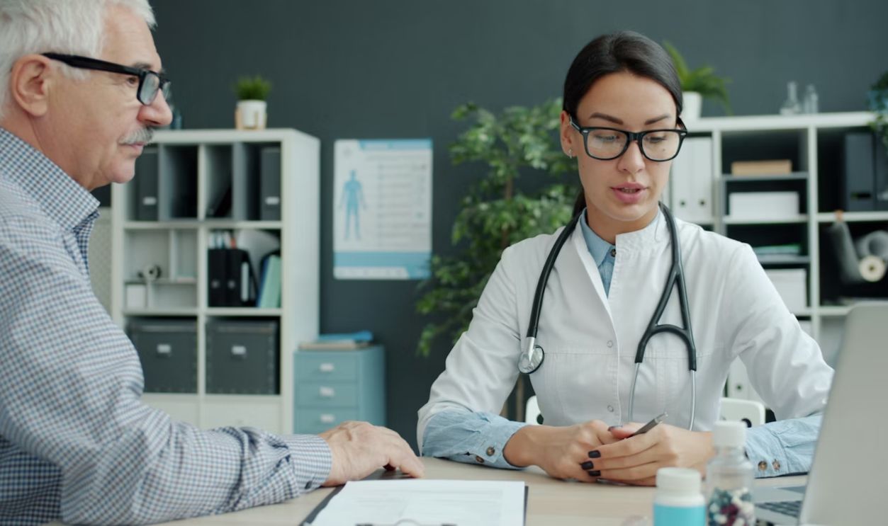 Doctor consulting with an elderly patient in an office