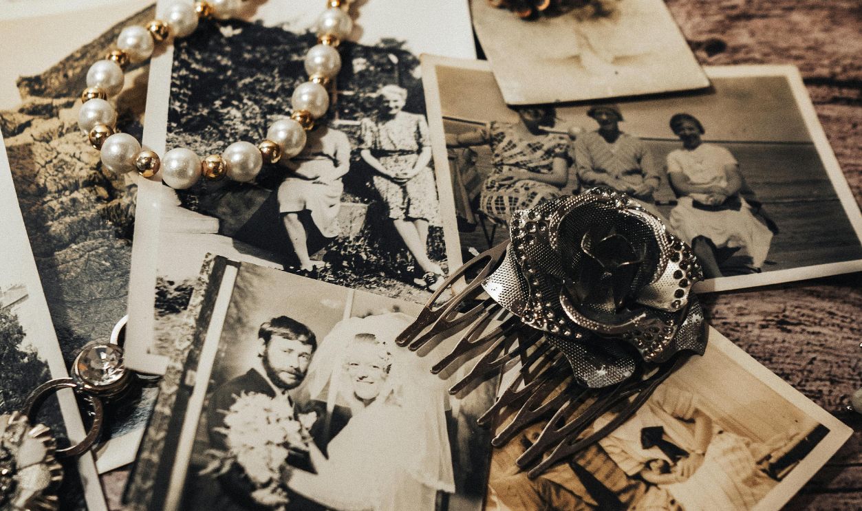 Vintage Photos and Heirloom Jewelry on Wooden Table