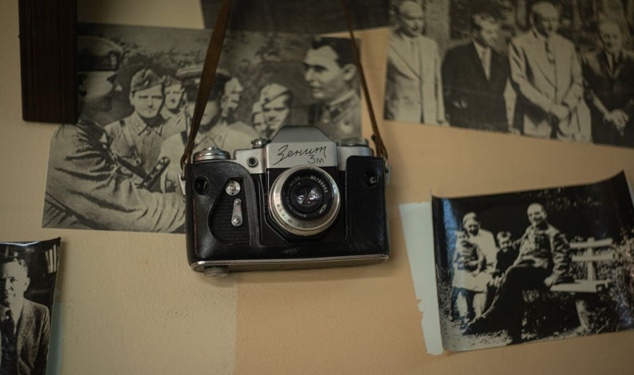 Retro Camera Lying among Photographs