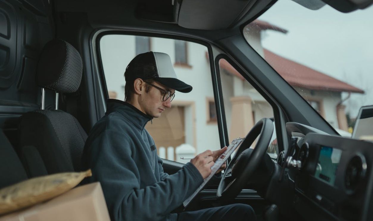 Delivery Man writing on a Paper