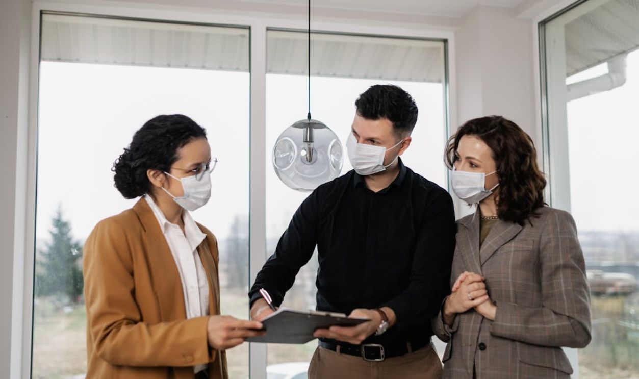 A Couple Signing a Contract with a Realtor