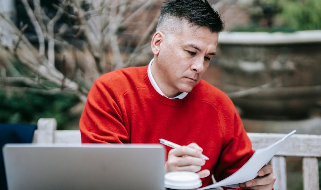 Photo Of Man Reviewing Documents