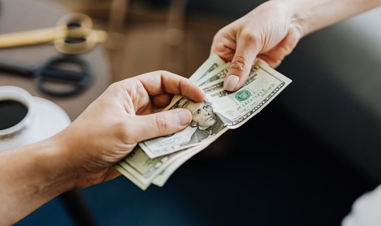 Hands Holding Us Dollar Bills