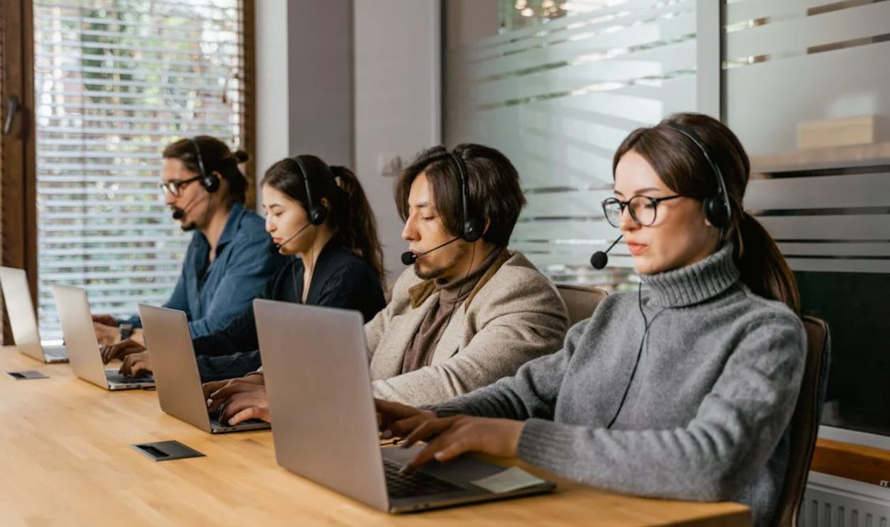 People Working in an Office with their Laptops