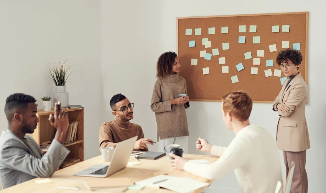 Women Standing beside Corkboard