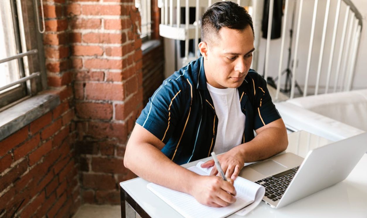 Man Studying Using a Laptop