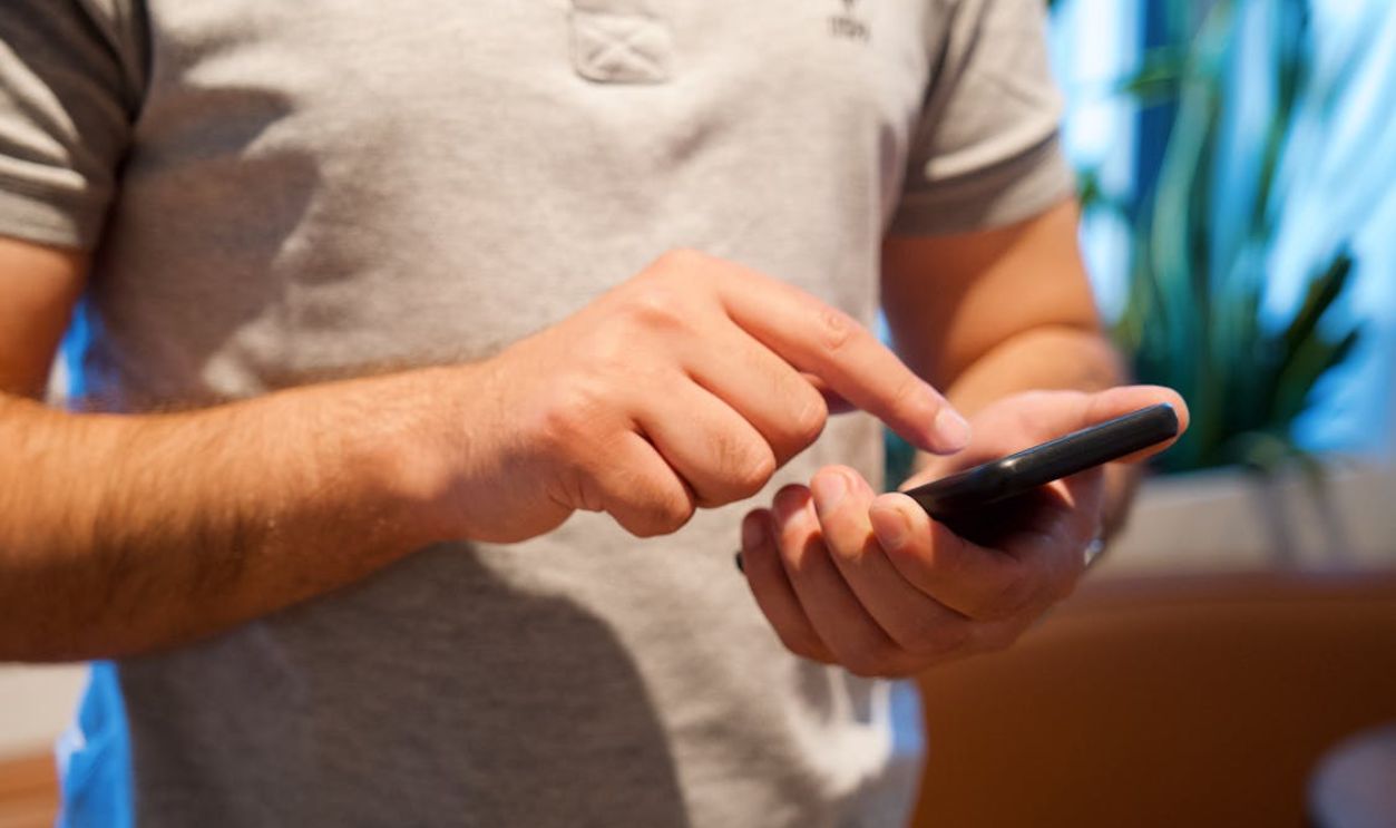 Man Tapping on Smartphone