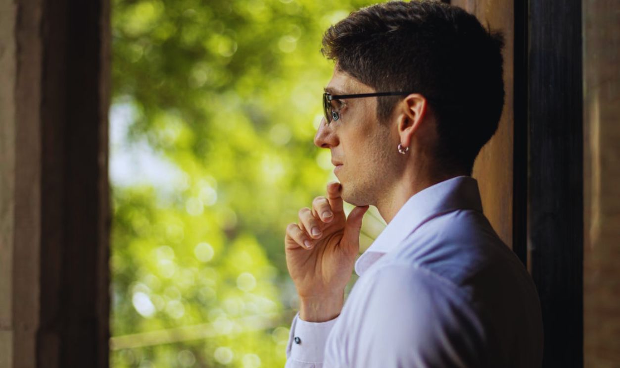 Thoughtful Man Looking Out Window in Buenos Aires