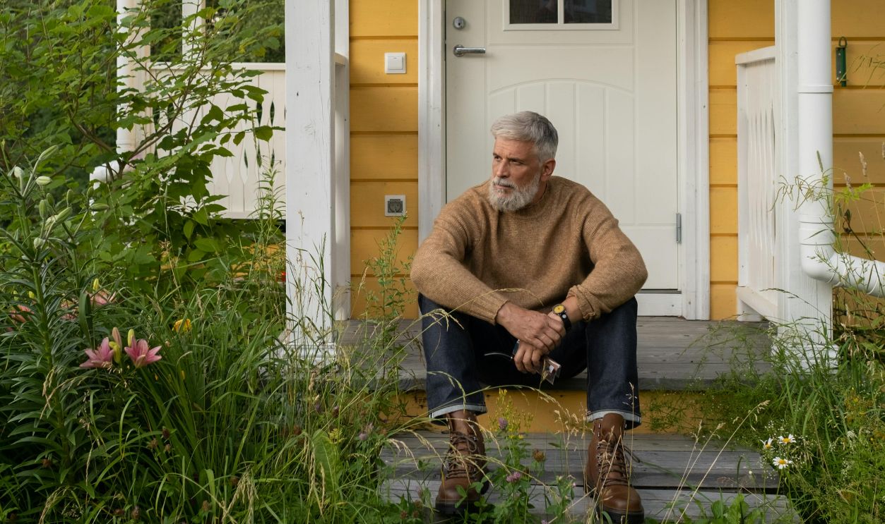 Elderly Man Sitting On Porch
