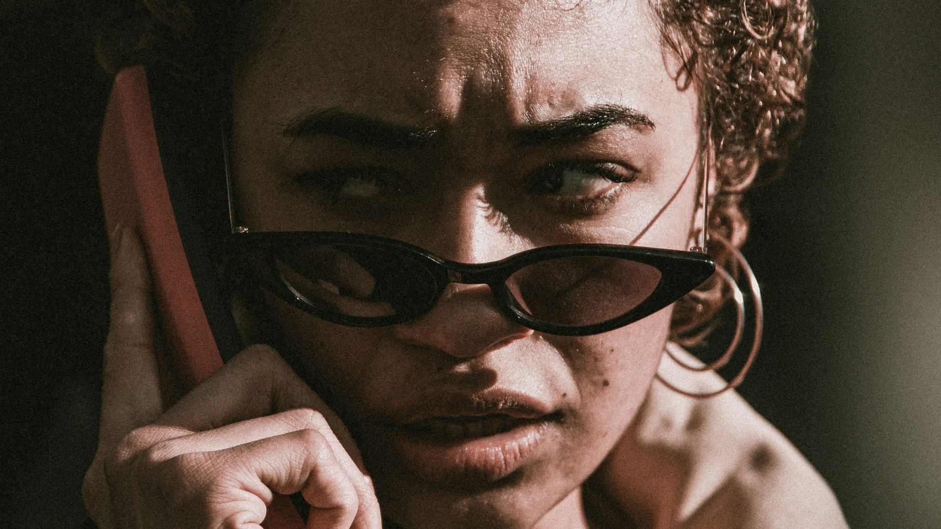 woman in black jacket wearing black sunglasses