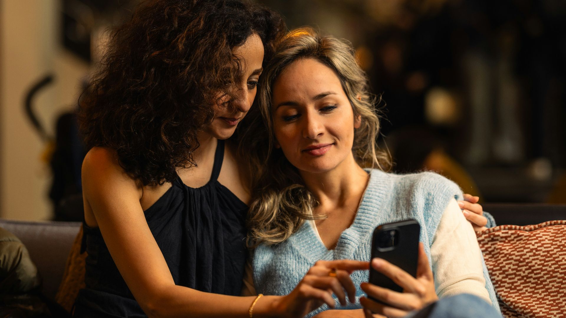 Two women looking at a smartphone together