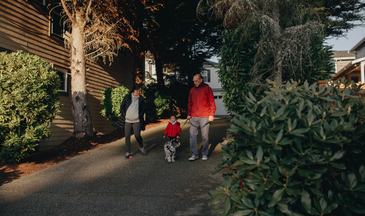 Man Walking The Dog With His Family