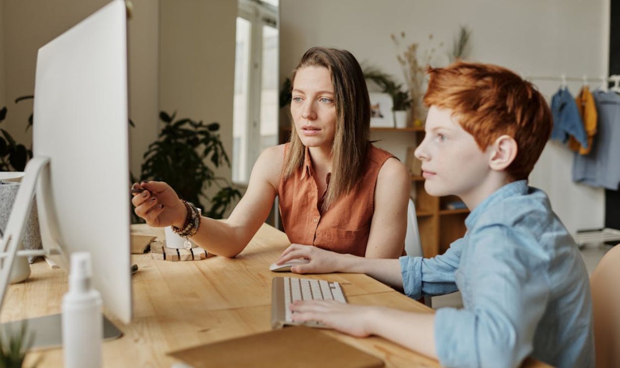Photo Of Woman Tutoring Young Boy